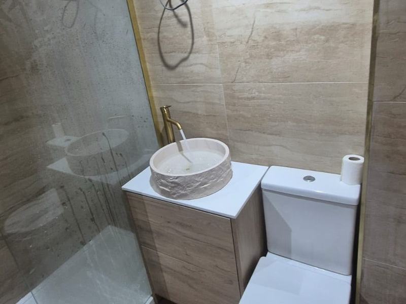 Finished shower room with glass shower screen and countertop basin