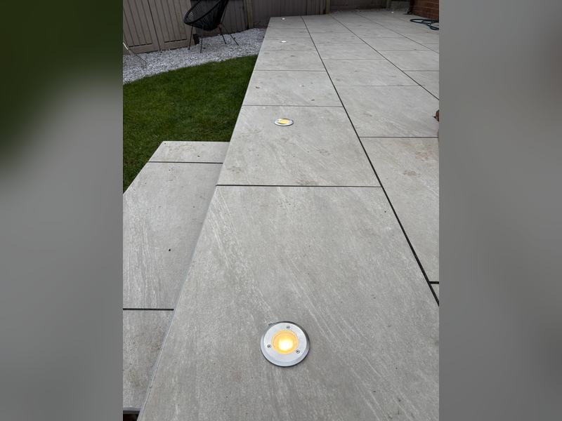 Low-level LED deck lights set into a porcelain patio